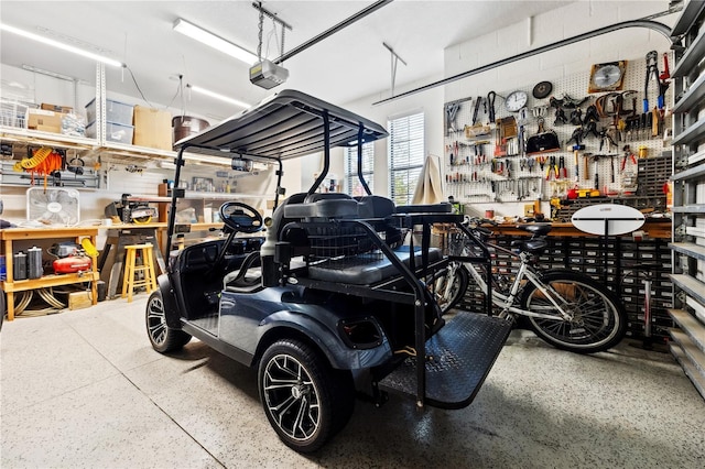 garage with a workshop area and a garage door opener