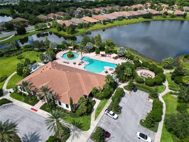birds eye view of property with a water view and a residential view