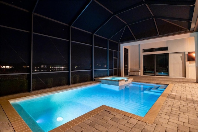 view of pool featuring a lanai, a patio area, and a pool with connected hot tub