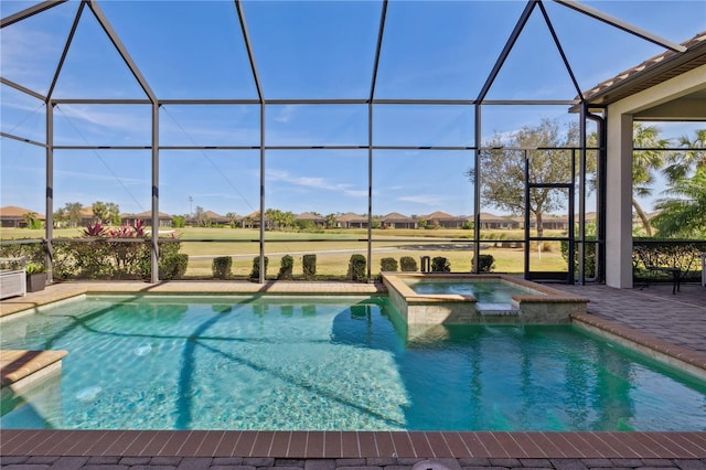 view of swimming pool with a pool with connected hot tub, glass enclosure, a residential view, and a patio area
