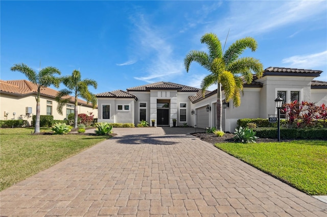 view of front of property featuring stucco siding, decorative driveway, and a tile roof