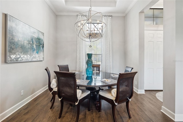 dining space featuring baseboards, a chandelier, crown molding, a tray ceiling, and dark wood finished floors