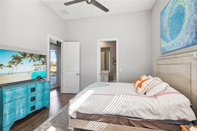 bedroom featuring visible vents, a ceiling fan, ensuite bathroom, and wood finished floors