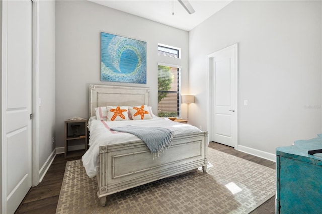bedroom featuring ceiling fan, baseboards, and dark wood-style floors