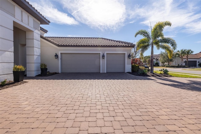 garage with decorative driveway