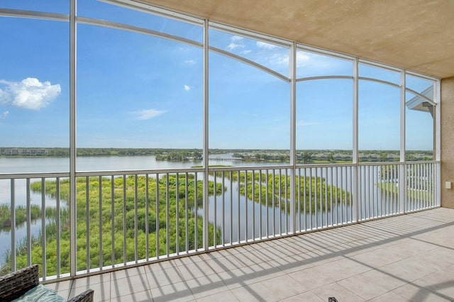 unfurnished sunroom featuring a water view