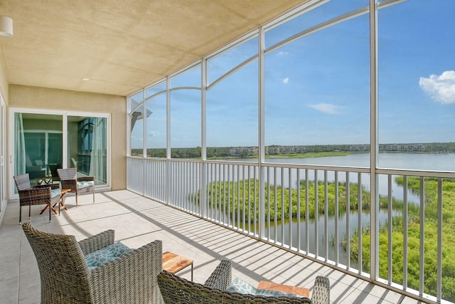 sunroom / solarium with a water view