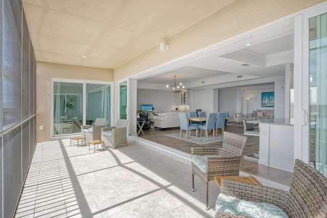 sunroom with a notable chandelier