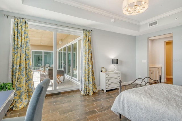 bedroom featuring visible vents, baseboards, access to exterior, wood tiled floor, and a tray ceiling