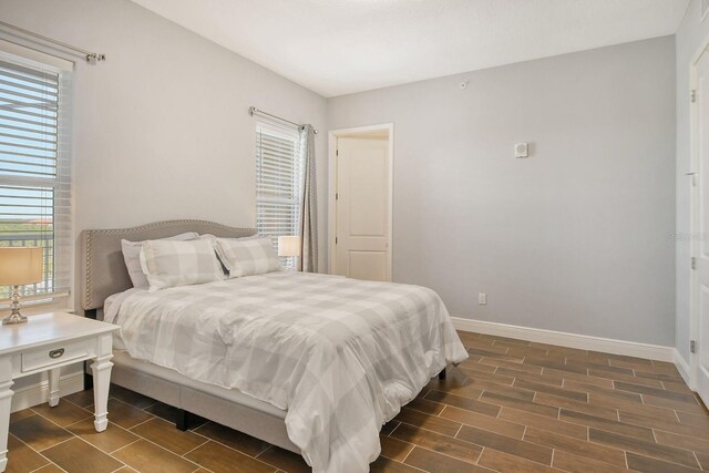 bedroom featuring wood finish floors and baseboards