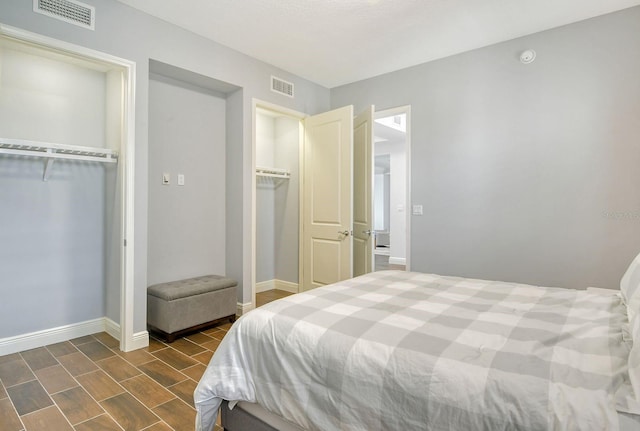 bedroom featuring visible vents and baseboards