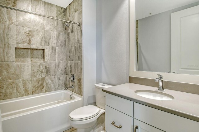 full bathroom with  shower combination, vanity, and toilet