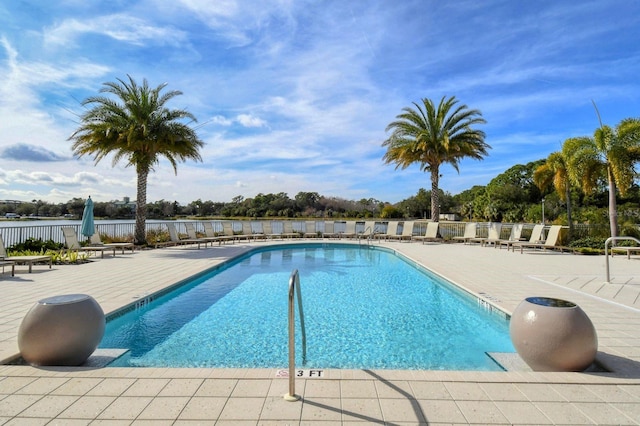 pool with fence and a patio