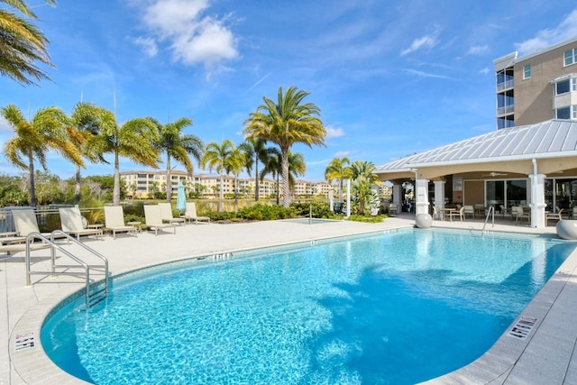 community pool featuring ceiling fan and a patio