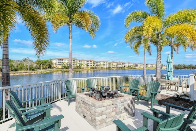 view of patio / terrace featuring a water view and a fire pit