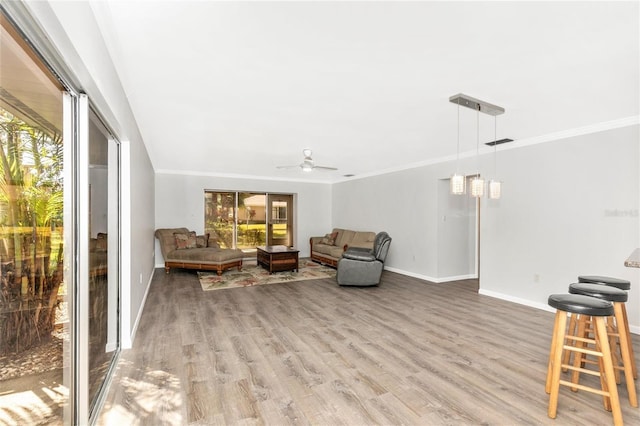 sitting room featuring ceiling fan, ornamental molding, and hardwood / wood-style floors