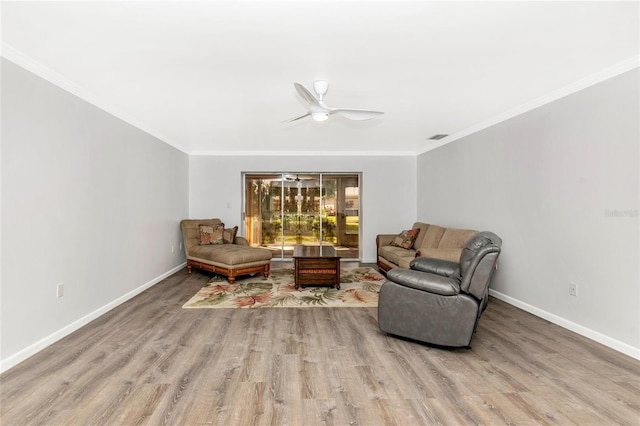 living area featuring crown molding, light hardwood / wood-style floors, and ceiling fan