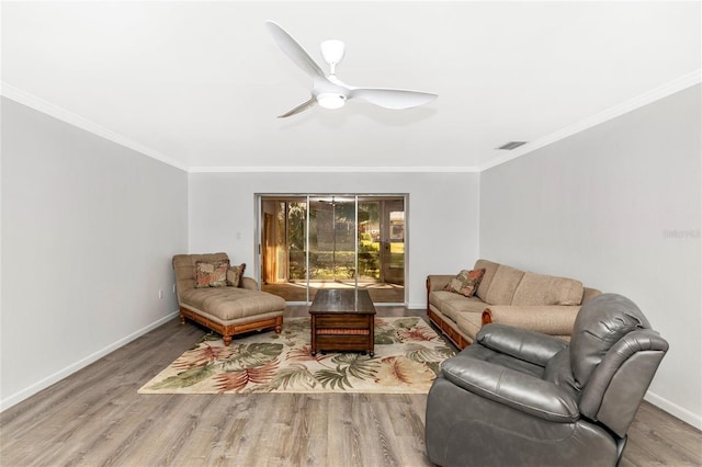 living room featuring ornamental molding, hardwood / wood-style floors, and ceiling fan