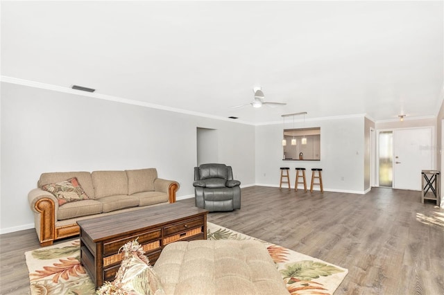 living room featuring crown molding, ceiling fan, and hardwood / wood-style floors