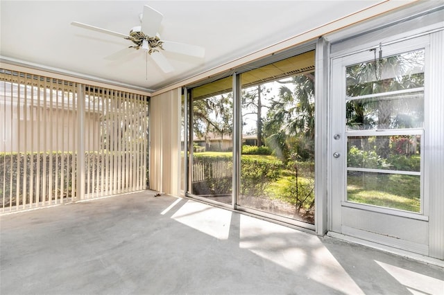 unfurnished sunroom with ceiling fan