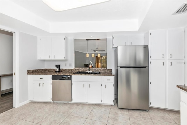 kitchen featuring white cabinetry, appliances with stainless steel finishes, sink, and dark stone counters