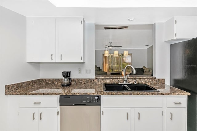 kitchen with white cabinetry, dishwasher, sink, and dark stone countertops