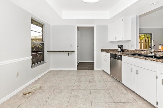 kitchen with white cabinetry, dishwasher, a healthy amount of sunlight, and light tile patterned floors