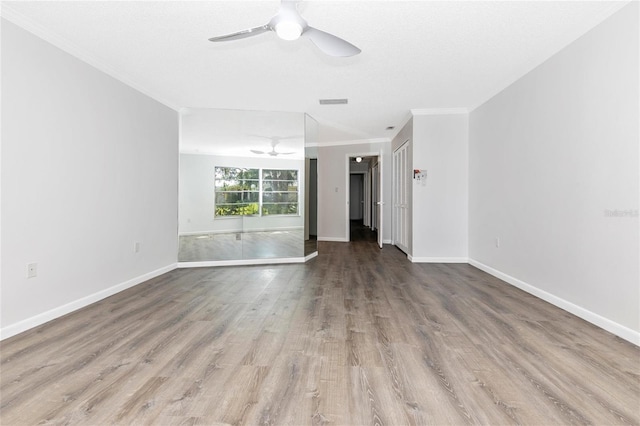 unfurnished living room featuring hardwood / wood-style flooring, ceiling fan, ornamental molding, and a textured ceiling