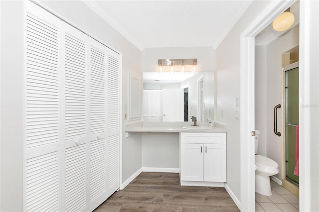 bathroom featuring vanity, toilet, an enclosed shower, and wood-type flooring