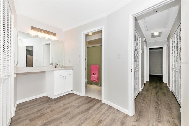 bathroom featuring vanity, hardwood / wood-style flooring, crown molding, and toilet