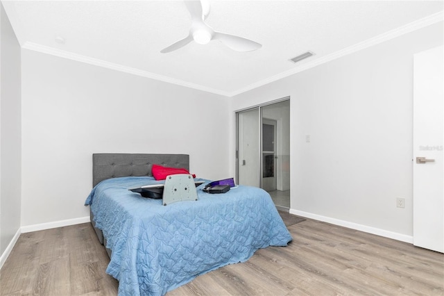 bedroom featuring wood-type flooring, ceiling fan, and crown molding