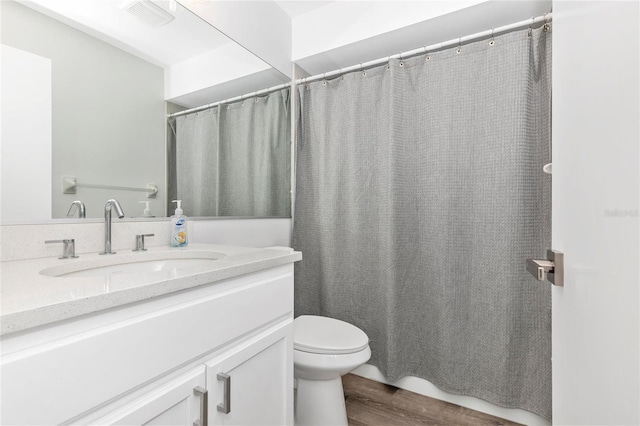 bathroom with vanity, hardwood / wood-style floors, and toilet