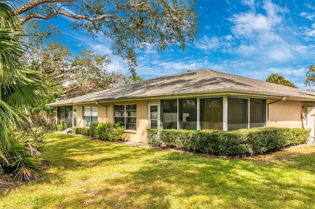 rear view of house with a yard