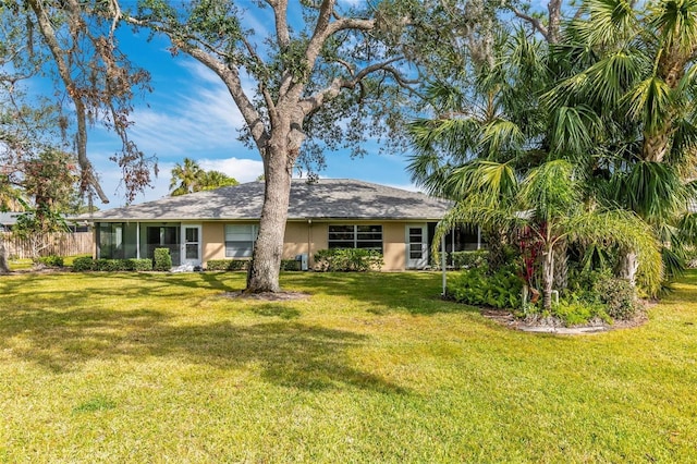 back of house with a lawn