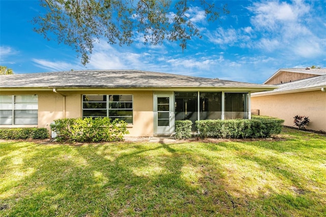 rear view of property featuring a yard