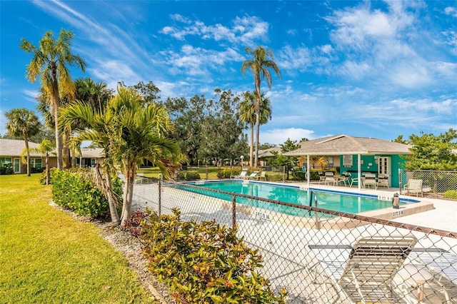 view of swimming pool featuring a yard and a patio area