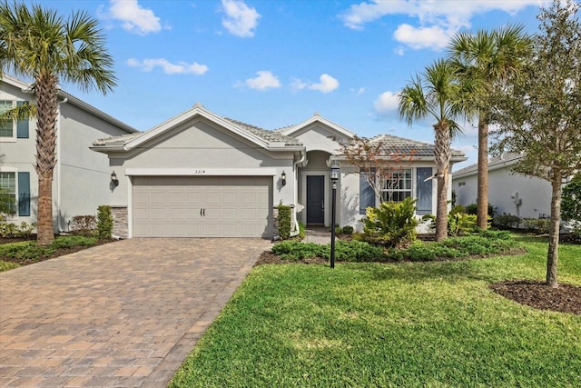 view of front of home with a garage and a front lawn