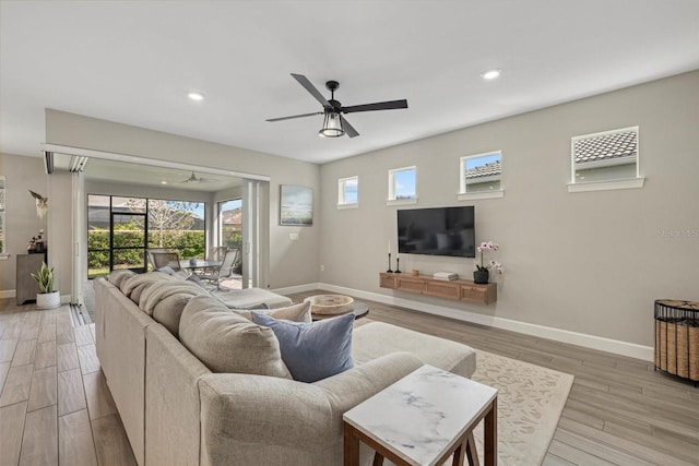 living room featuring ceiling fan and light wood-type flooring