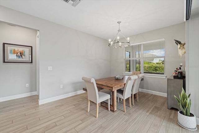 dining room featuring a notable chandelier and light hardwood / wood-style flooring