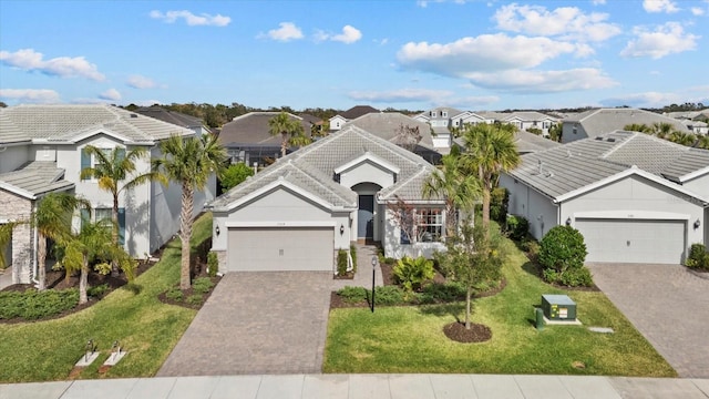 view of front of home with a garage and a front yard