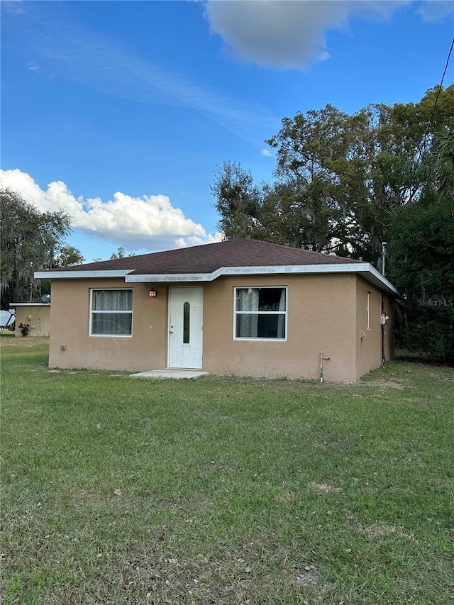 ranch-style house with a front lawn