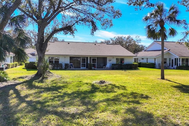 back of house with a lawn