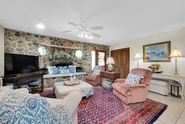 living room featuring light tile patterned flooring and ceiling fan