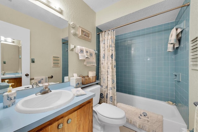 full bathroom with vanity, a textured ceiling, shower / bath combination with curtain, and toilet