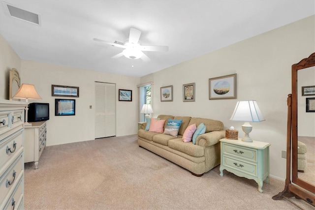 living room featuring ceiling fan and light carpet