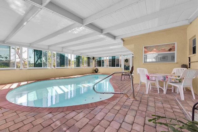 indoor pool featuring a patio area