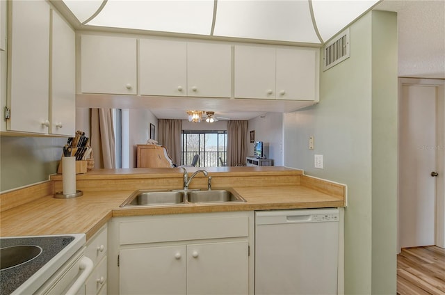 kitchen with white cabinetry, sink, dishwasher, and light wood-type flooring