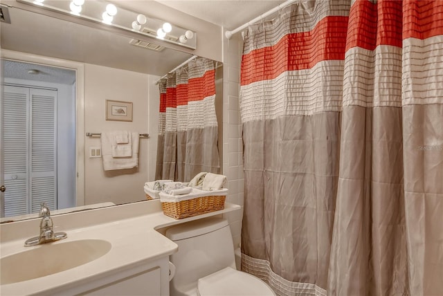 bathroom with vanity, walk in shower, and toilet