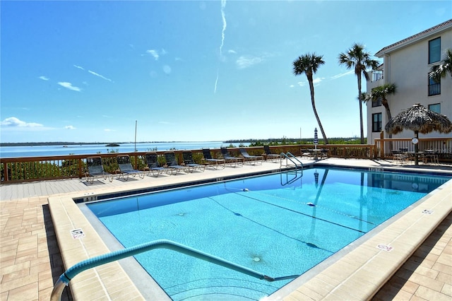 view of pool with a water view