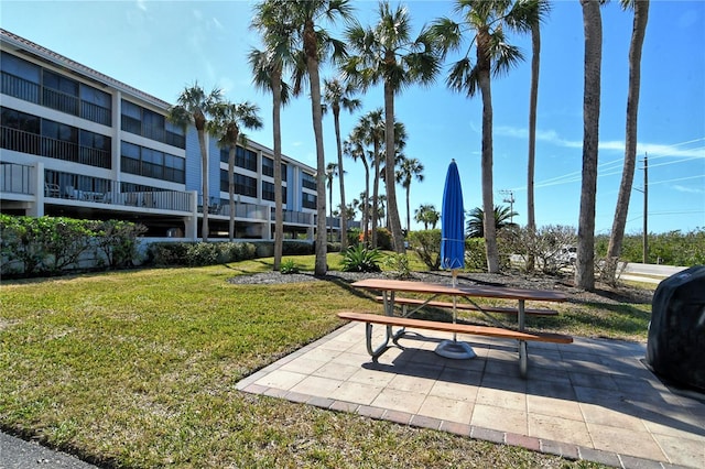 view of community with a yard and a patio